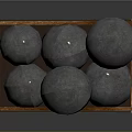 Multiple Shiny Silver Round Metal Balls in Wooden Storage Box