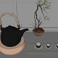 Elegant Black Teapot with Bamboo Handle on Beige Base and Teacups on Bamboo Mat