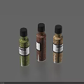Three Spice Bottles With Green Brown Yellow Spices Black Caps Labels And Gray Background