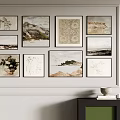 White Wall With Multiple Framed Paintings And Green Cabinet With Bowl And Books