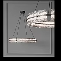 Modern Circular Chandelier With Textured Glass Rings And Black Metal Hanging In Interior