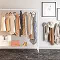 Stylish Clothes on White Rack with Dresses Coats Scarves Hats Bags Shoes and Wall Art