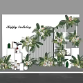 Happy Birthday Party Decor With Floral Arrangements Green Plants And White Background