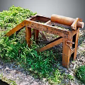 Rusty Metal Frame Equipment With Roller Standing Among Green Grass And Gravel