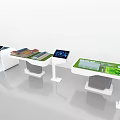 Interactive Sand Table Display With Digital Screens On White Stands And Green Surfaces 3d model