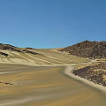 Scenic Garden Landscape Featuring Rolling Sand Dunes And Rocky Outcrops