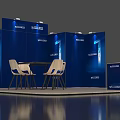 Blue Exhibition Booth With Display Panels Round Table White Chairs And Reception Desk