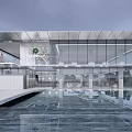 Modern Sales Office Building With Glass Curtain Wall And Pool Water Reflection Greenery