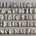 Various White Stone Sculptures Arranged on Wooden Shelves in Neat Rows