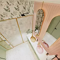 Hotel Bathroom Interior With Pink And Green Design Floral Tiles Vanity Mirror And Cabinets