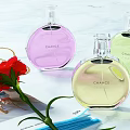 Chanel Perfume Cosmetics Collection with Colorful Bottles White Flowers Coffee and Jewelry