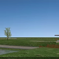 Wooden Arch Bridge Over Water With Green Grass And Paved Path Under Blue Sky