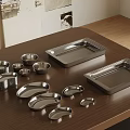 Stainless Steel Tableware Set With Various Plates Bowls And Trays On Wooden Table