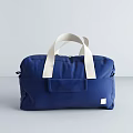 Stylish Blue Duffel Bag With White Handles Front Pocket And Minimalist Design