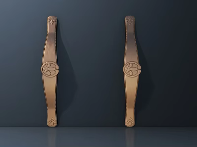 Two Decorative Brass Cabinet Handles With Ornate Patterns On Dark Wall 3d model