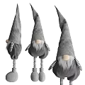 Gray Plush Dolls with Pointed Hats Striped Sleeves sitting on Yellow Block