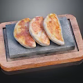 Three Crispy Golden Fried Dumplings on Stone Slab in Wooden Tray