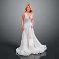 Elegant Woman Wearing White Long Dress With Deep V Neck And Fluffy Hem Against Grey Background