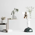 Modern Side Tables Featuring Marble Bases Metal Accents Vases Plants and Statue