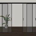 Black Frame Glass Sliding Doors With Potted Plant In Wooden Floor Interior Space