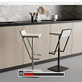 Modern Bar Stools With White Seats And Metal Frames At Kitchen Counter With Wooden Cabinets