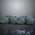 Green Plants In Multiple Gray Bird Shaped Pots With Slender Stems And Small Flowers