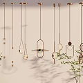 Stylish Copper Pendant Lights With Various Designs Hanging On White Wall With Green Plants