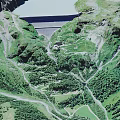 Scenic Natural Landscape With Green Mountain Valleys Winding Roads And Dam Structure