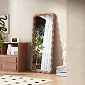 Scalloped Edge Wooden Frame Mirror Reflected Tree And Curtain In Room With Bookshelf And Plants