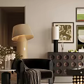 Black Lounge Chair With Beige Table Lamp White Flowers And Decorative Paintings Near Dark Cabinet