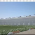 Modern Industrial Factory Building With Glass Curtain Walls Metal Roof And Green Surroundings