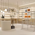 Modern Stylish Boutique Interior With Metal Display Racks Round Counter Pendant Lights And Green Plants