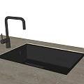 Black Kitchen Sink Installed in Light Colored Stone Countertop with Silver Faucet