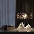 Modern Table Lamp With White Textured Base Sparkling Shade Warm Glow And Stack Of Books