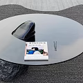 Modern Round Glass Coffee Table Featuring Black Stone Base Kinfolk Magazine And Pen