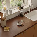 Wooden Kitchen Countertop With White Sink Coffee Cup Toast And Utensils
