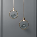 Modern Pendant Lights with Golden Ring Design and Transparent Glass Sphere on Gray Wall