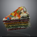 Rainbow Colored Cake With Layers Of Cream Topped With Colorful Sprinkles