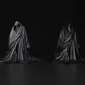 Two Black Hooded Robes With Drapey Fabric On Dark Background