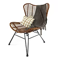 Wicker Lounge Chair With Plaid Pillow And Linen Blanket On Black Metal Frame
