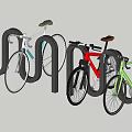 Colored Bicycles Parked at Black U Bicycle Rack on Green Grass and Concrete Pavement