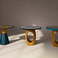 Three Round Dining Tables With Different Colored Bases And Circular Patterned Tops On 3d model