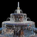 Elegant Multi Tiered Garden Fountain Ornament With Circular Stone Base And Flowing Water