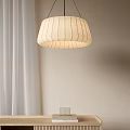 Cream Colored Pendant Light With Vertical Stripes Hanging Near White Curtains And Light Colored Wall