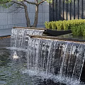 Multi Tiered Water Fountain With Flowing Water Surrounding Greenery Background Wall And Trees