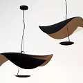 Modern Curved Pendant Lights With Black And Brown Leaf Shaped Design Suspended From Ceiling