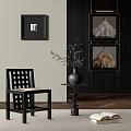 Elegant Portrait Paintings in Black Frames Hanging on Dark Wall With Decorative Chair and Vase