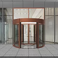 Modern Building Entrance With Bronze Revolving Door And Glass Curtain Wall