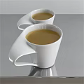 Two White Ceramic Cups With Yellow Beverage Placed On Shiny Silver Tabletop 3d model