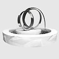 Modern Garden Ornament with Metal Rings and Water Feature on White Polygonal Base